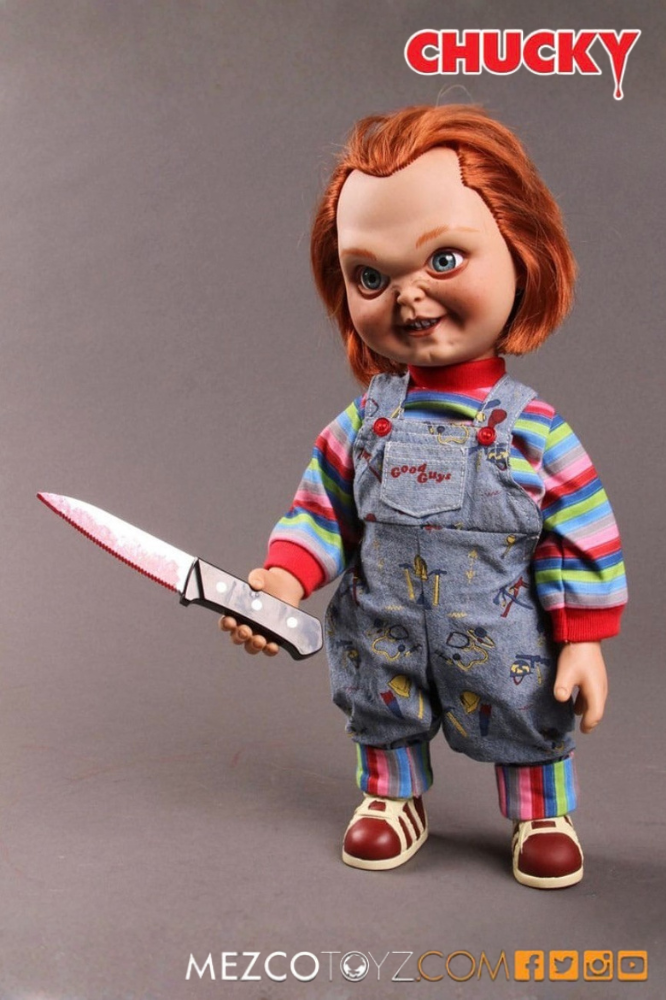 Muñeca Sneering Chucky de El Muñeco Diabólico fabricada por Mezco Toyz, 38 cm de altura, con sonido, pelo pelirrojo, peto Good Guys y expresión maliciosa.