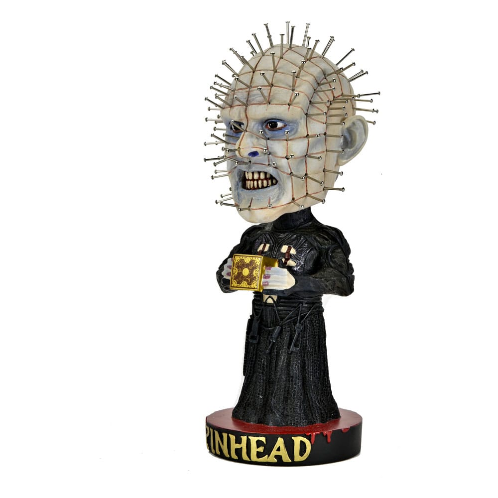 Figura Head Knocker de Pinhead de Hellraiser fabricada por NECA, con su característica apariencia cenobita y la caja Lemarchand.