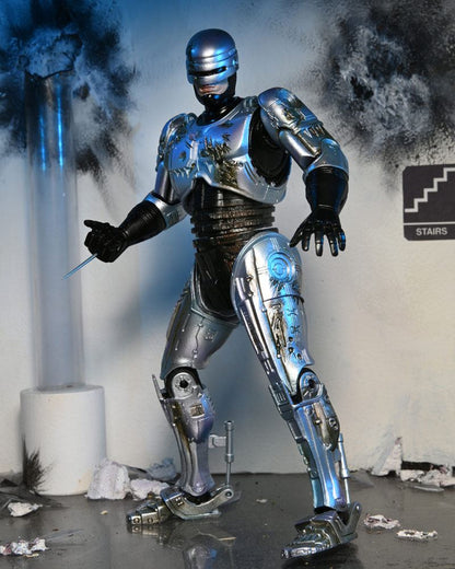 ROBOCOP ULTIMATE BATTLE DAMAGED WITH CHAIR – FIGURA 18 CM (NECA – ROBOCOP)