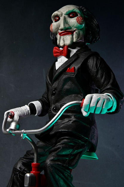 BILLY WITH TRICYCLE – SAW FIGURE WITH SOUND 30 CM (NECA – SAW)